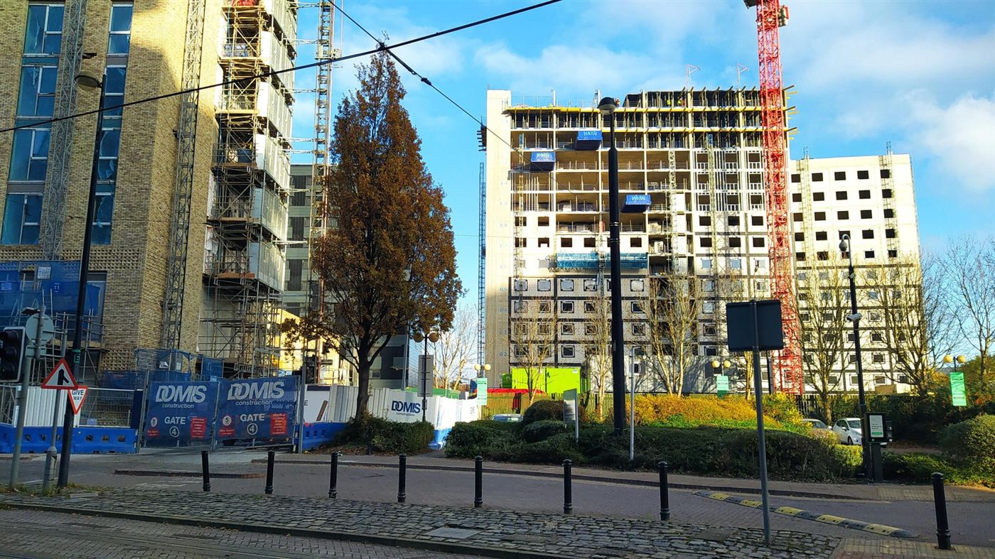 City centre residential tower under construction, concrete frame stage, DOMIS Construction hoarding in view