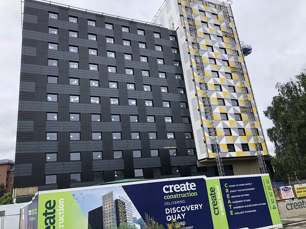 Discovery Quay, Salford — student accommodation tower under construction, Create Construction hoarding in view