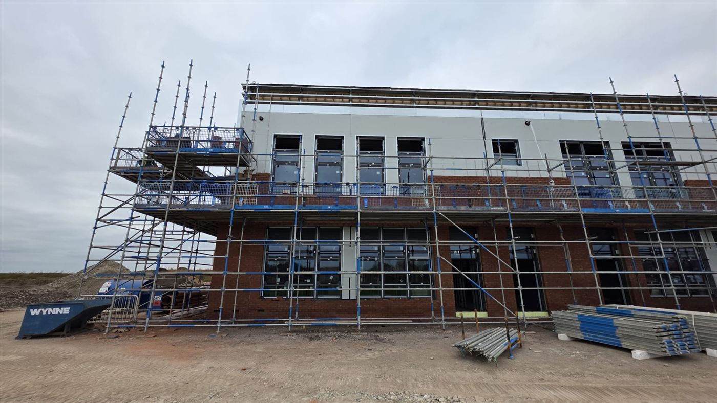 New school building under construction, brick and render facade, Wynne Construction site